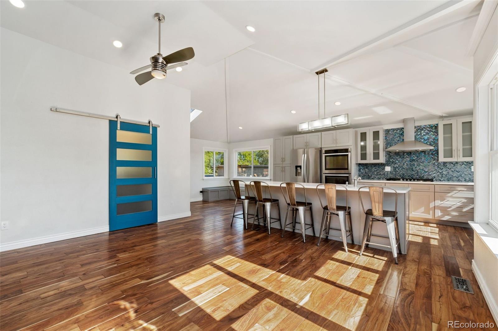 4545 Ingalls Street Wheat Ridge, CO 80033 - Photo 9 of 30 a view of a big room with dining room wooden floor and windows