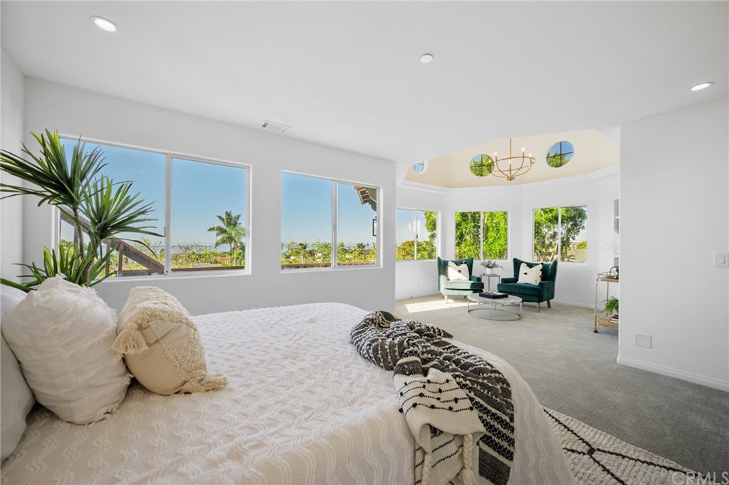 a spacious bedroom with a bed and a couch