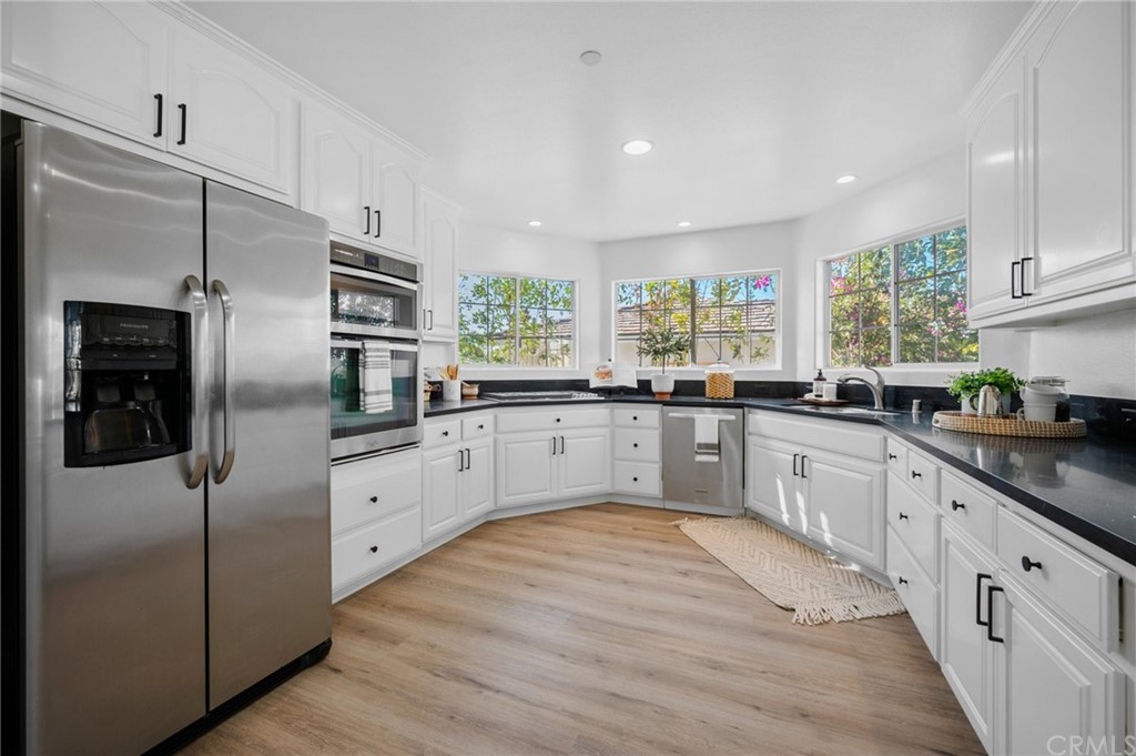 101 Esplanade San Clemente, CA 92672 - Photo 12 of 54 a large kitchen with cabinets stainless steel appliances and a window