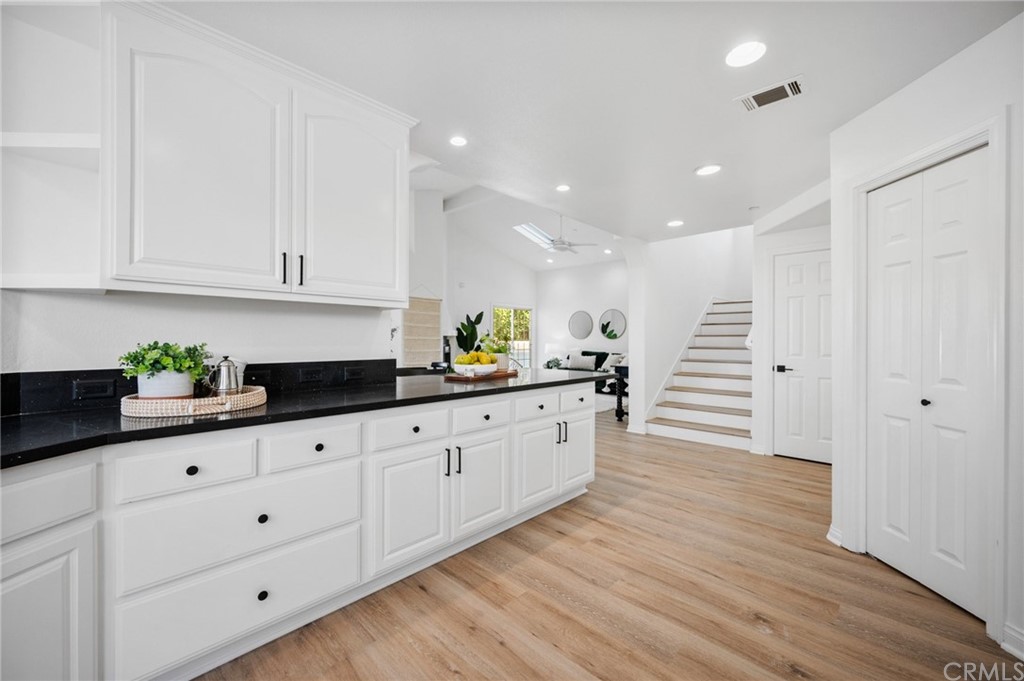 101 Esplanade San Clemente, CA 92672 - Photo 15 of 54 a kitchen with granite countertop white cabinets and white appliances