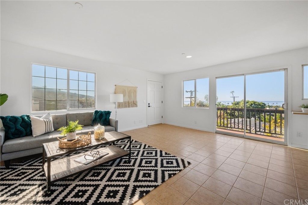 101 Esplanade San Clemente, CA 92672 - Photo 28 of 54 a living room with furniture and a floor to ceiling window