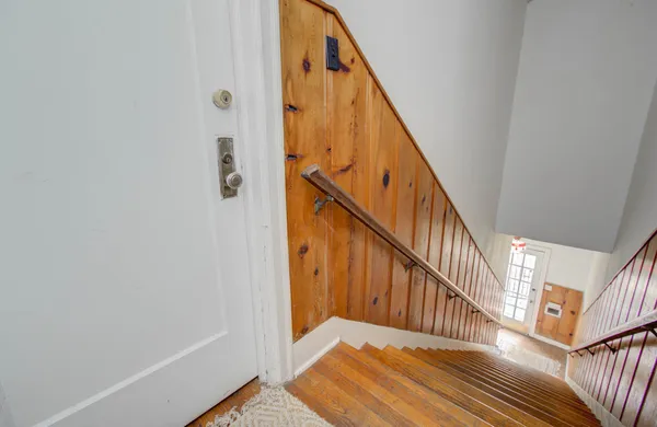 a view of staircase with wooden floor and stairs