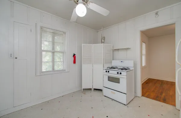 a kitchen with cabinets appliances and a window
