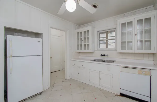 a spacious bathroom with a double vanity sink a mirror and a bathtub