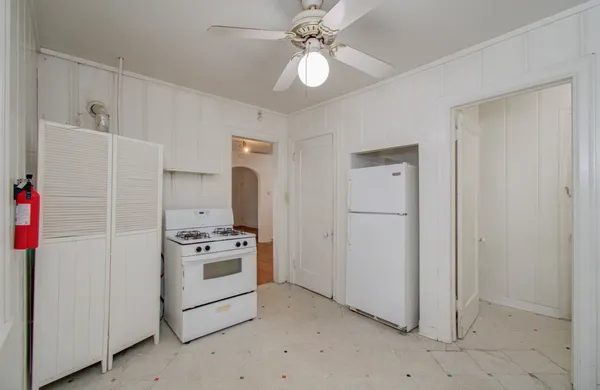 a kitchen with a refrigerator and a stove
