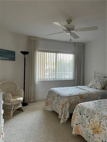 a bedroom with two beds and a window