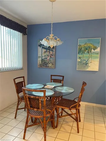 a view of a dining room with furniture and chandelier