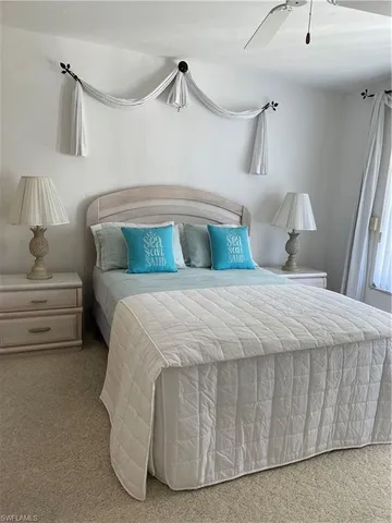 a bedroom with a bed and a mirror