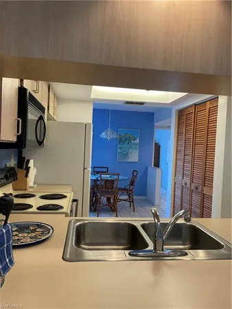 a kitchen with a sink and a stove top oven