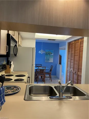 a kitchen with a sink and a stove top oven