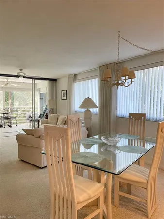 a living room with furniture a table and chairs
