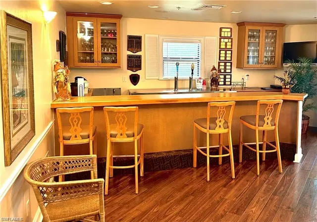 a view of a room with wooden floor and windows