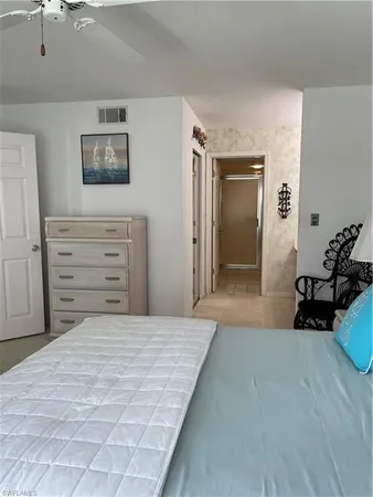 a bedroom with a bed and a dresser