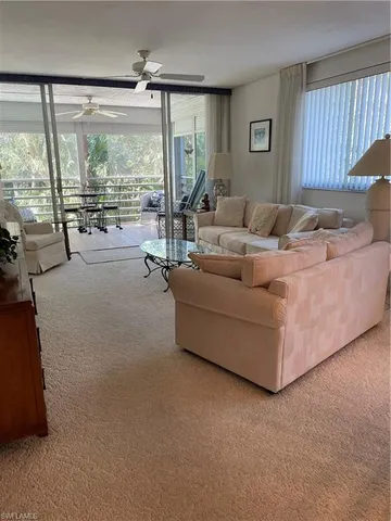 a living room with couches and a large window with outer view