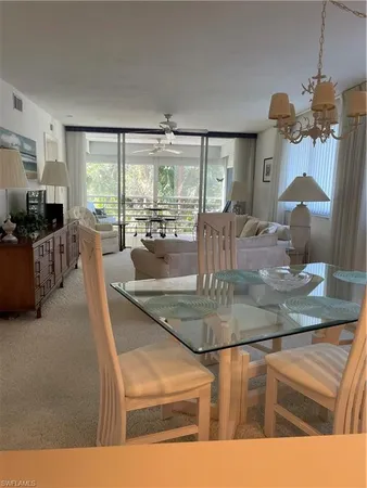 a kitchen with kitchen island a counter top space appliances and a view of living room