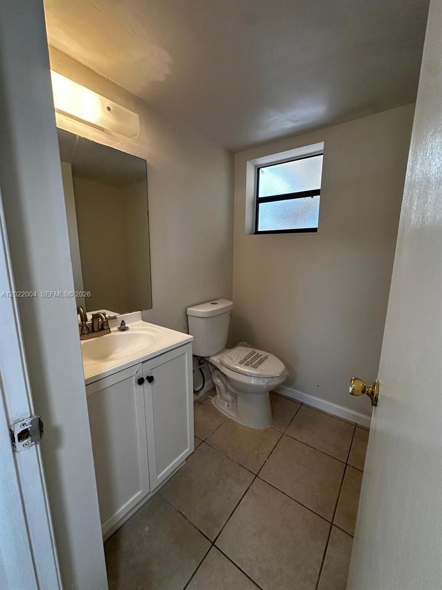 3400 Foxcroft Road, Unit 301 Miramar, FL 33025 - Photo 21 of 72 a bathroom with a sink a toilet and mirror