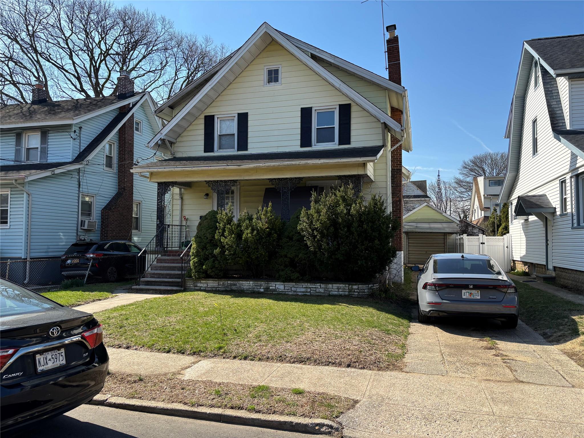 a view of a house with backyard sitting area and garden