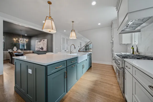 a kitchen with granite countertop a white stove top oven and cabinets