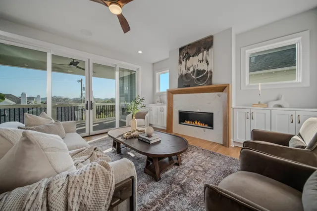 a bedroom with a bed ceiling fan and a window