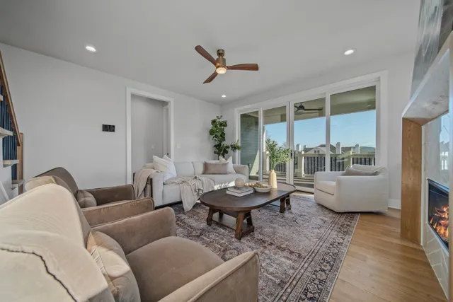a view of a livingroom with wooden floor and stairs