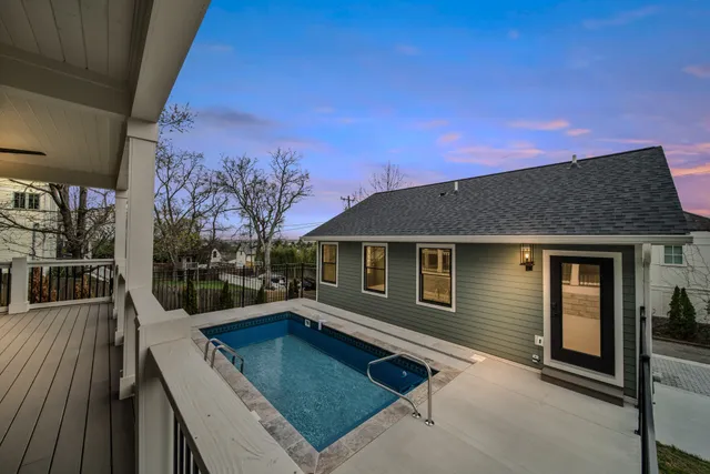 an aerial view of a house with a garden and lake view