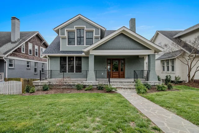 a view of hallway with stairs and wooden floor