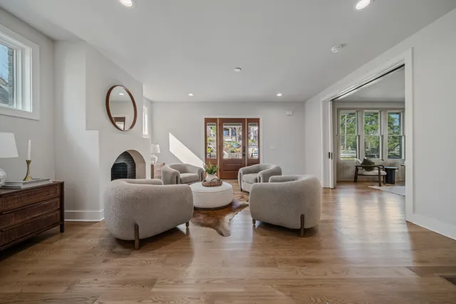 a living room with furniture and a floor to ceiling window