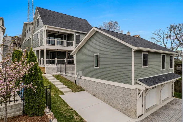 an empty room with wooden floor ceiling fan and windows