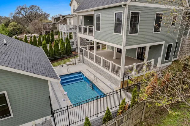 a view of a kitchen with a sink and dishwasher a refrigerator with wooden floor