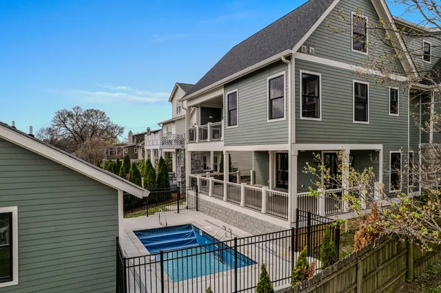 a bathroom with a bathtub shower sink vanity mirror and toilet