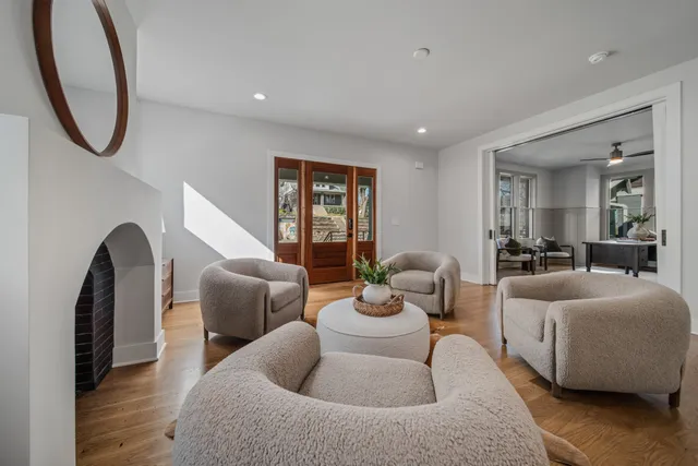 a living room with furniture a window and a chandelier