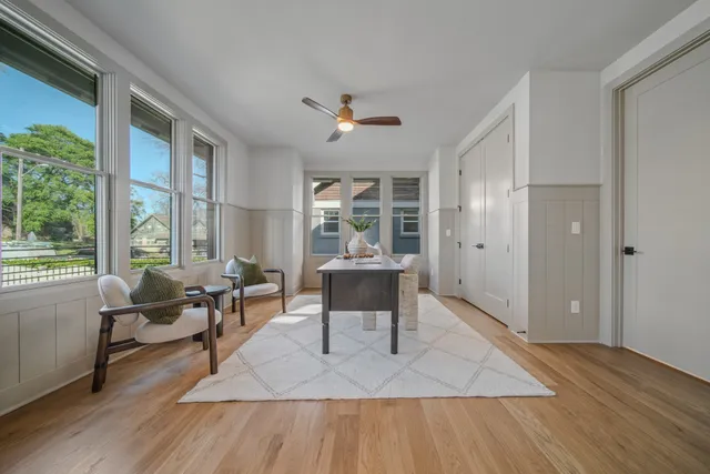 a kitchen with a sink a counter space and a view of living room