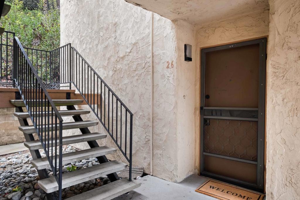 6775 Alvarado Road, Unit 26 San Diego, CA 92120 - Photo 4 of 24 a view of staircase with wooden floor and white walls