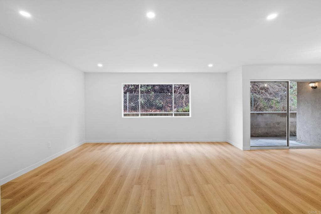 6775 Alvarado Road, Unit 26 San Diego, CA 92120 - Photo 7 of 24 an empty room with wooden floor and windows