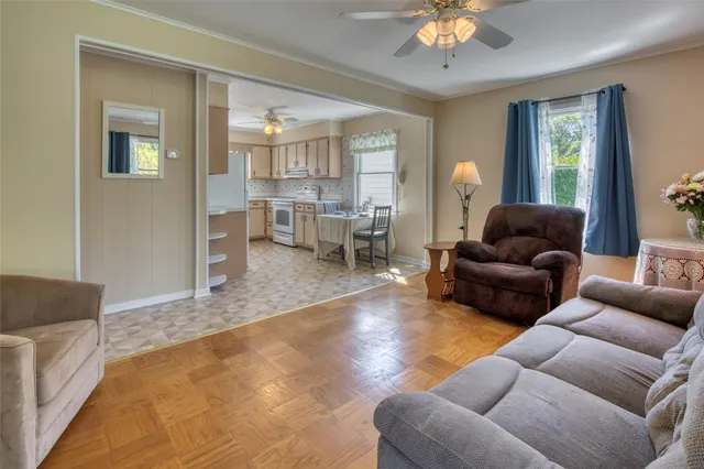 a living room with furniture and a chandelier