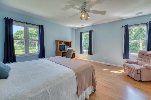 a bedroom with a large bed and a window