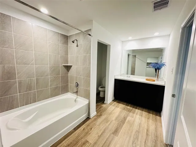 a bathroom with a bathtub and a sink