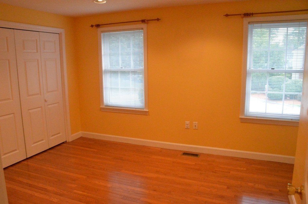 61 Stonegate Road Chelmsford, MA 01824 - Photo 11 of 17 a view of an empty room with wooden floor and a window