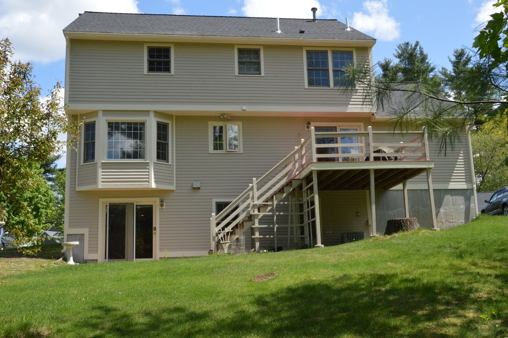 61 Stonegate Road Chelmsford, MA 01824 - Photo 2 of 17 a front view of a house with a yard
