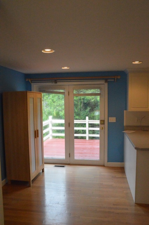 61 Stonegate Road Chelmsford, MA 01824 - Photo 4 of 17 an empty room with wooden floor and windows