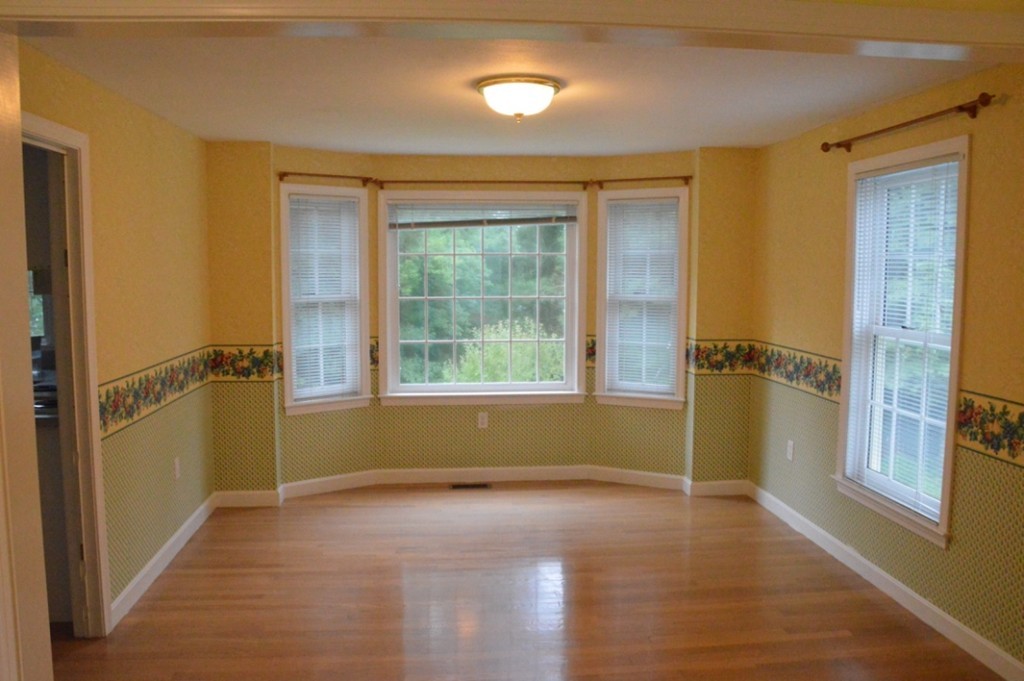 61 Stonegate Road Chelmsford, MA 01824 - Photo 6 of 17 a view of hallway with a window and wooden floor