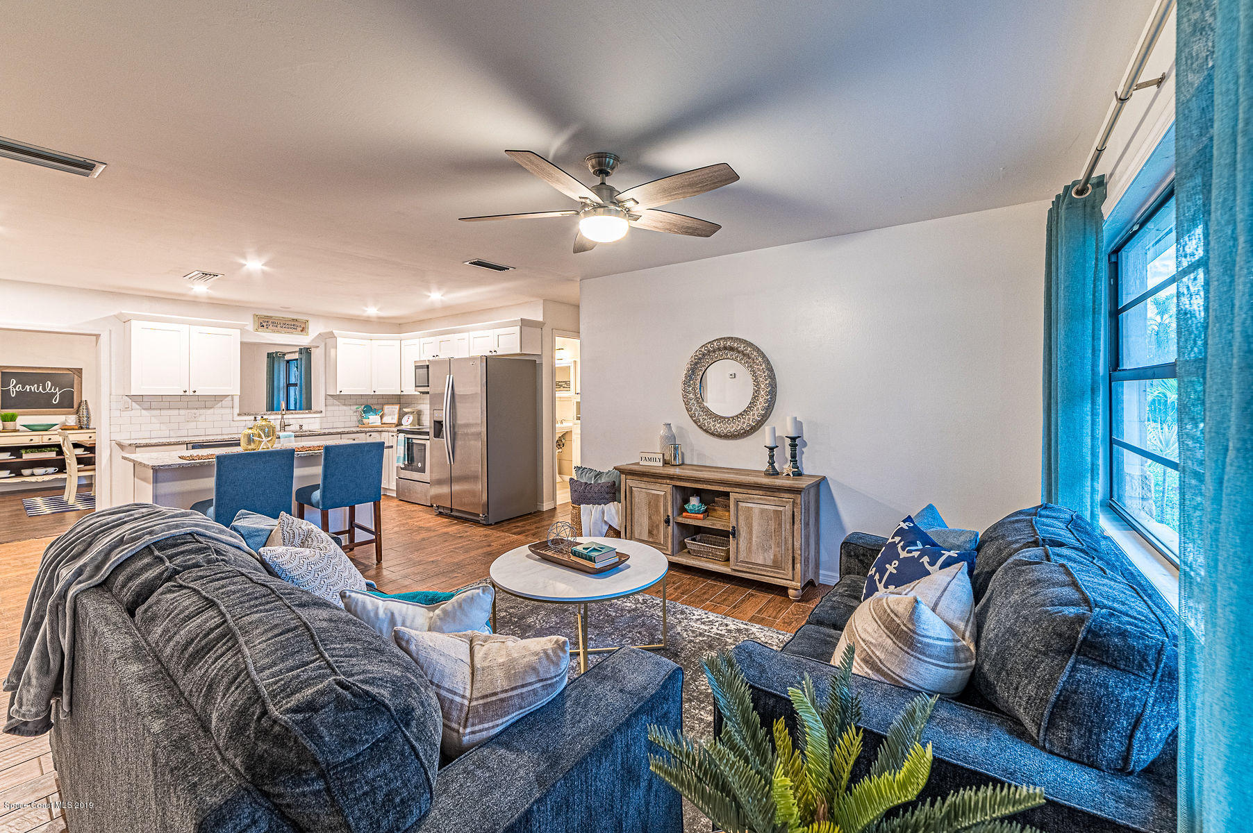 496 Seacrest Avenue Merritt Island, FL 32952 - Photo 1 of 33 a living room with furniture kitchen view and a window