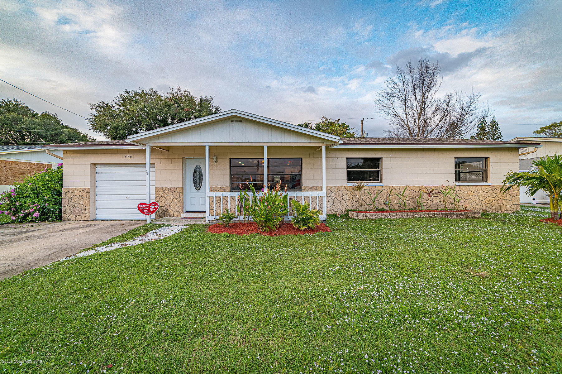 496 Seacrest Avenue Merritt Island, FL 32952 - Photo 2 of 33 a front view of house with yard and green space