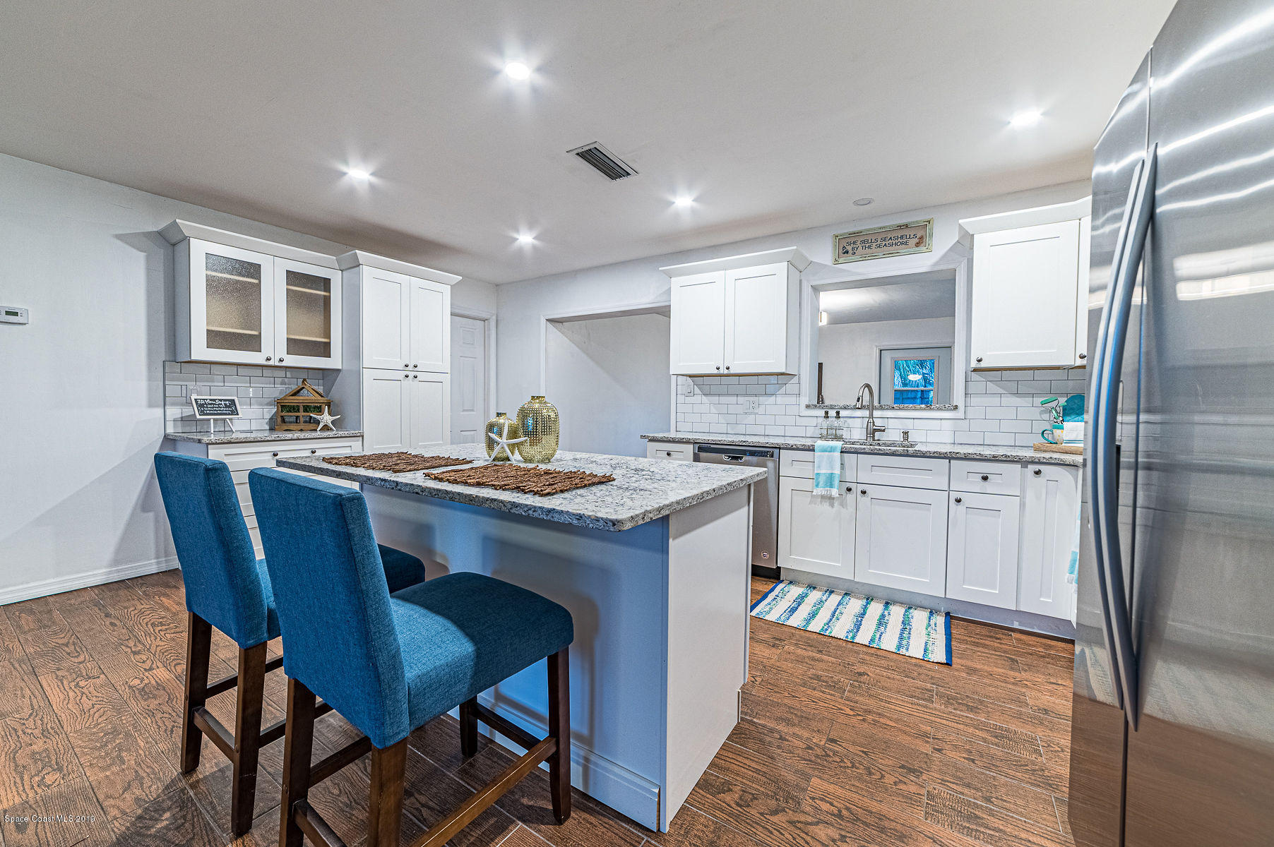 496 Seacrest Avenue Merritt Island, FL 32952 - Photo 13 of 33 a kitchen with granite countertop a sink appliances cabinets and furniture