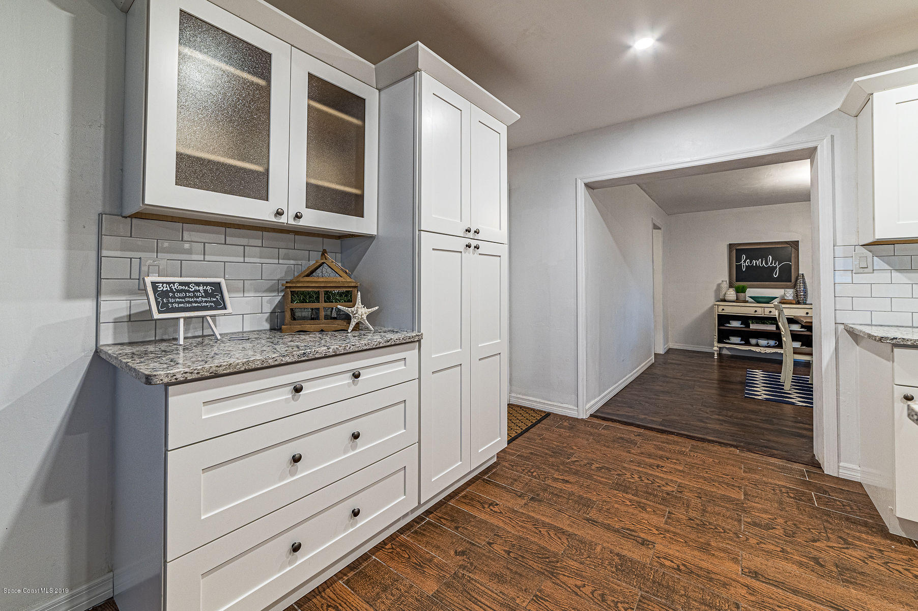 496 Seacrest Avenue Merritt Island, FL 32952 - Photo 14 of 33 a kitchen with granite countertop cabinets appliances and wooden floor