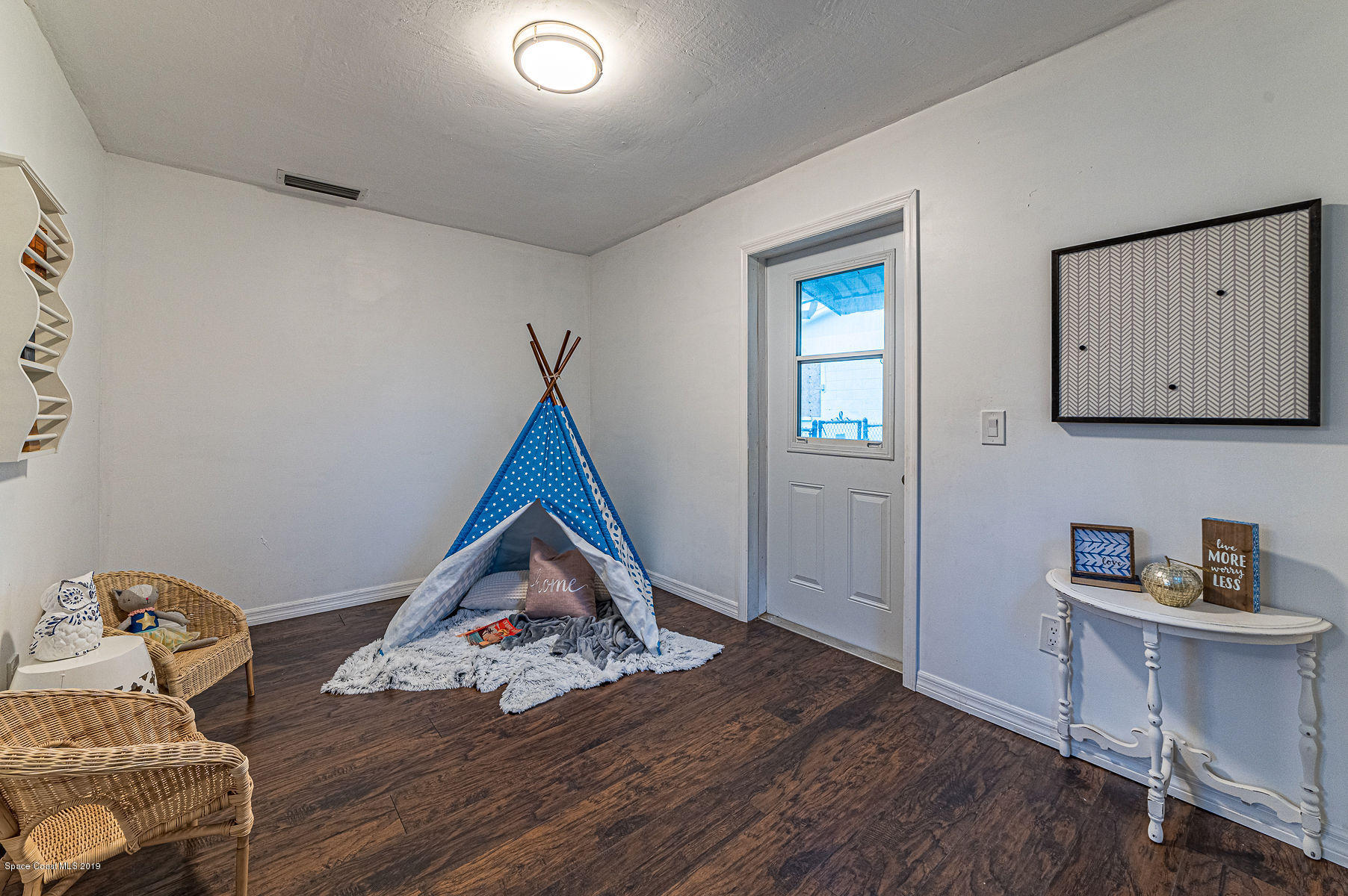 496 Seacrest Avenue Merritt Island, FL 32952 - Photo 20 of 33 a room with furniture and wooden floor