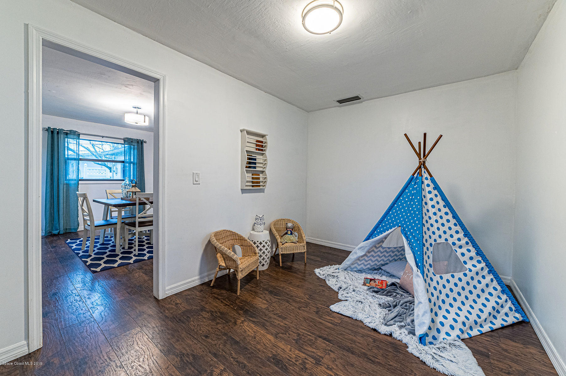 496 Seacrest Avenue Merritt Island, FL 32952 - Photo 21 of 33 a living room with furniture and a wooden floor