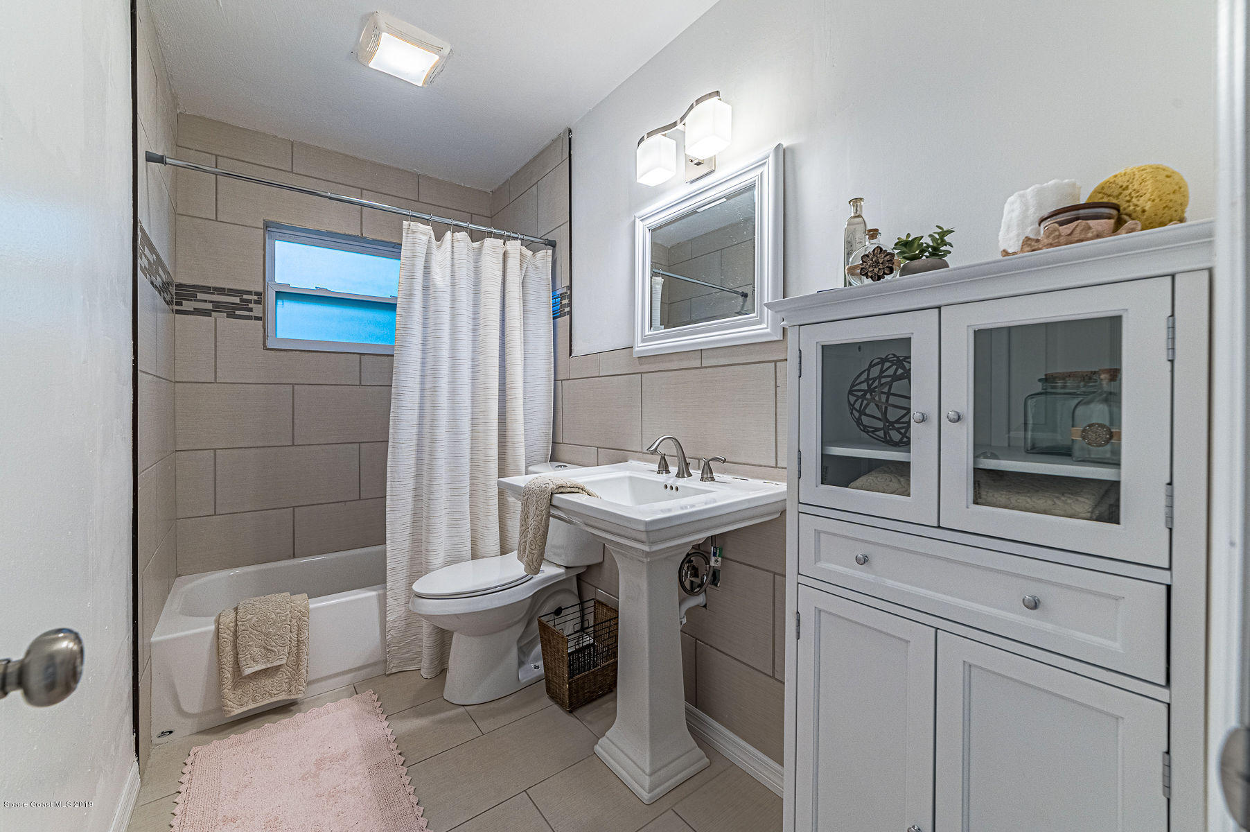 496 Seacrest Avenue Merritt Island, FL 32952 - Photo 23 of 33 a view of a bathroom with a sink and a toilet