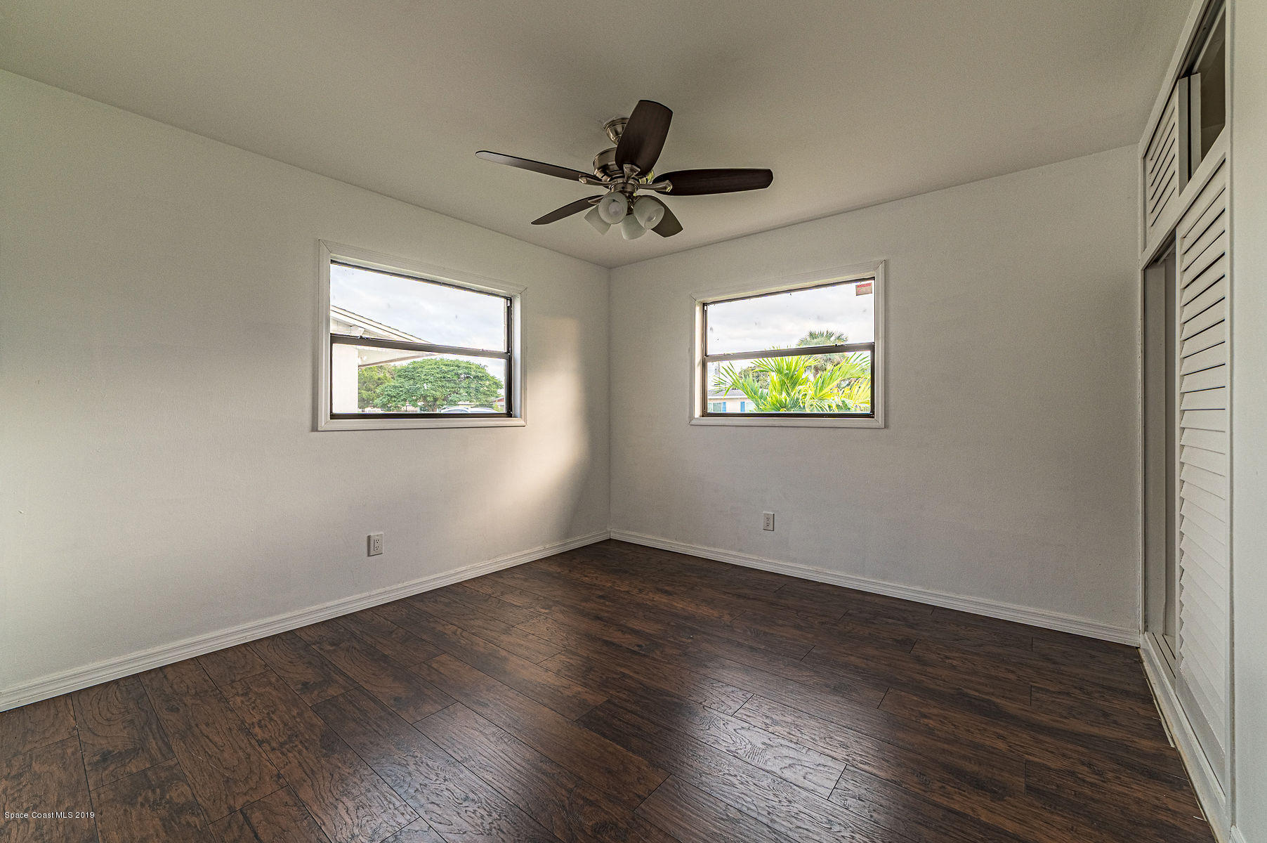 496 Seacrest Avenue Merritt Island, FL 32952 - Photo 26 of 33 wooden floor in an empty room with a window