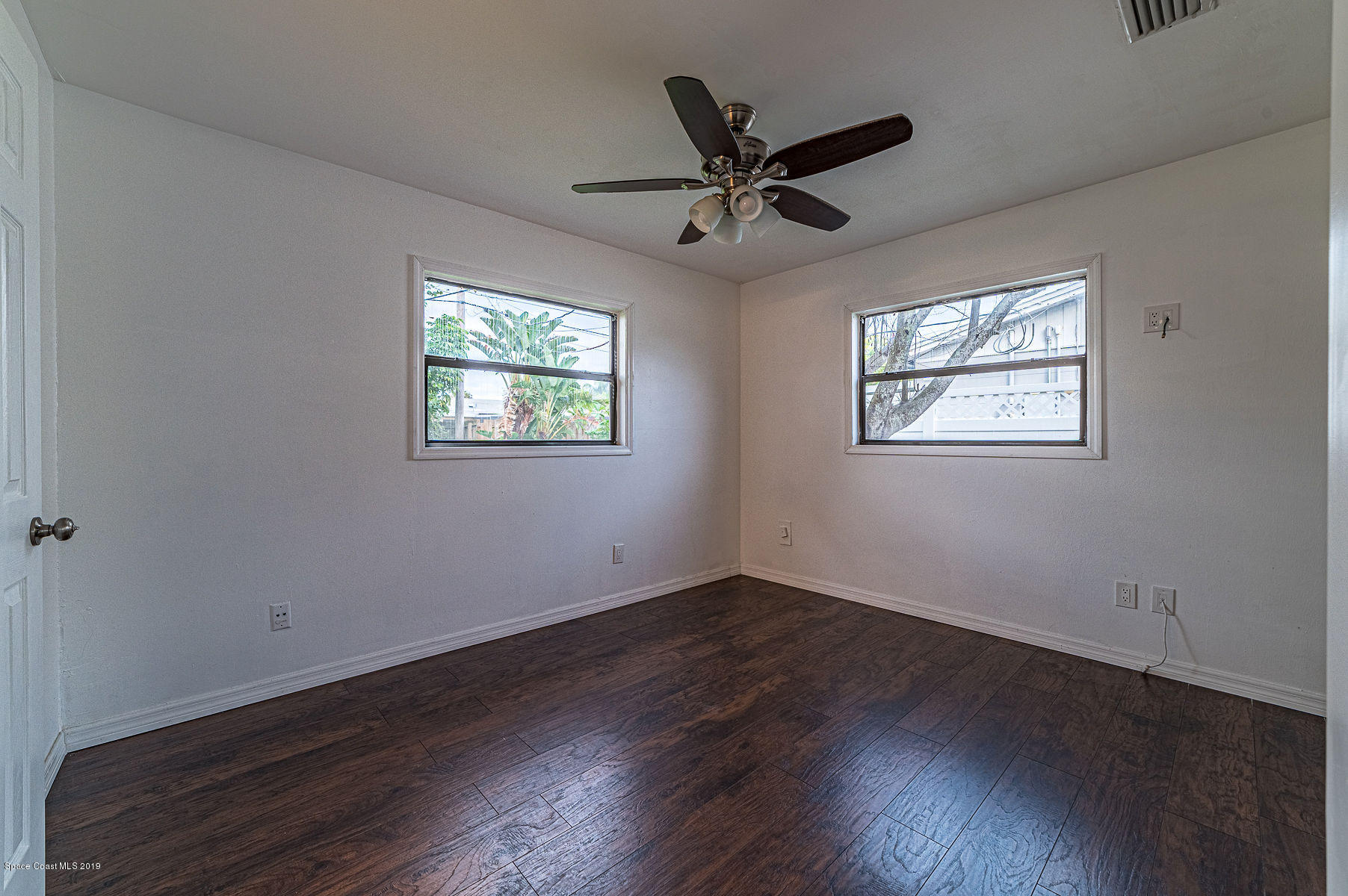 496 Seacrest Avenue Merritt Island, FL 32952 - Photo 28 of 33 a view of a big room with wooden floor and windows